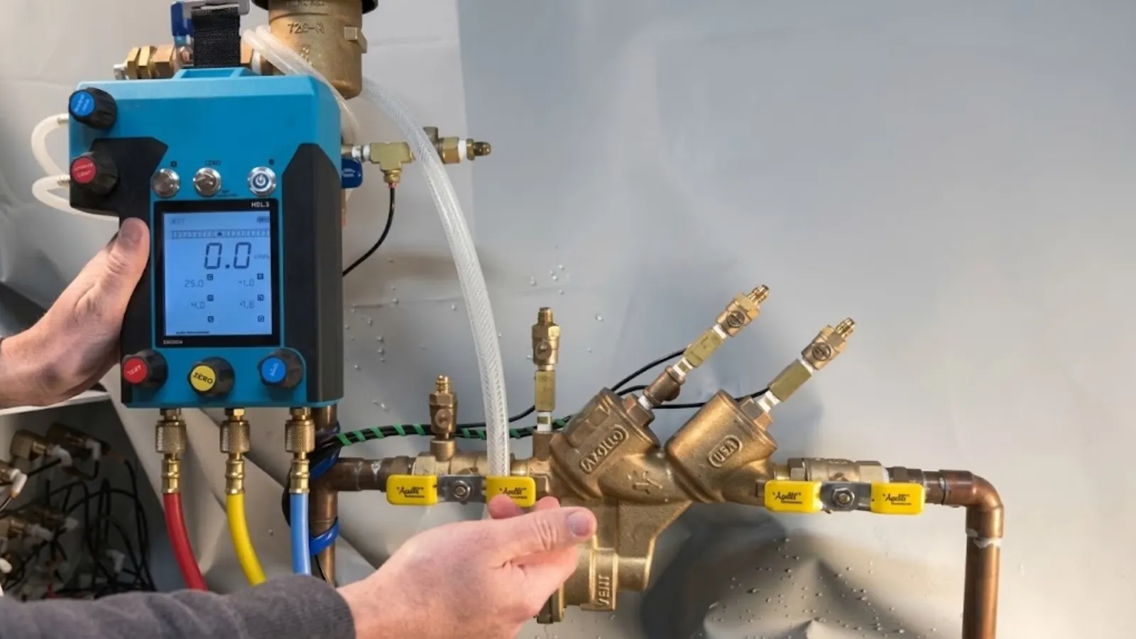 Backflow test kit gauge connected to a backflow prevention assembly