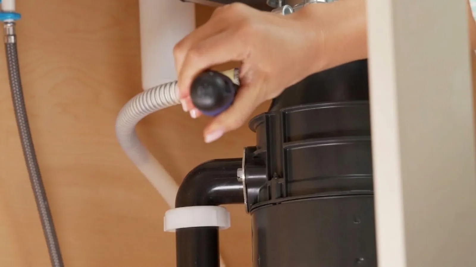 Garbage disposal unit and drain connection being installed under a sink