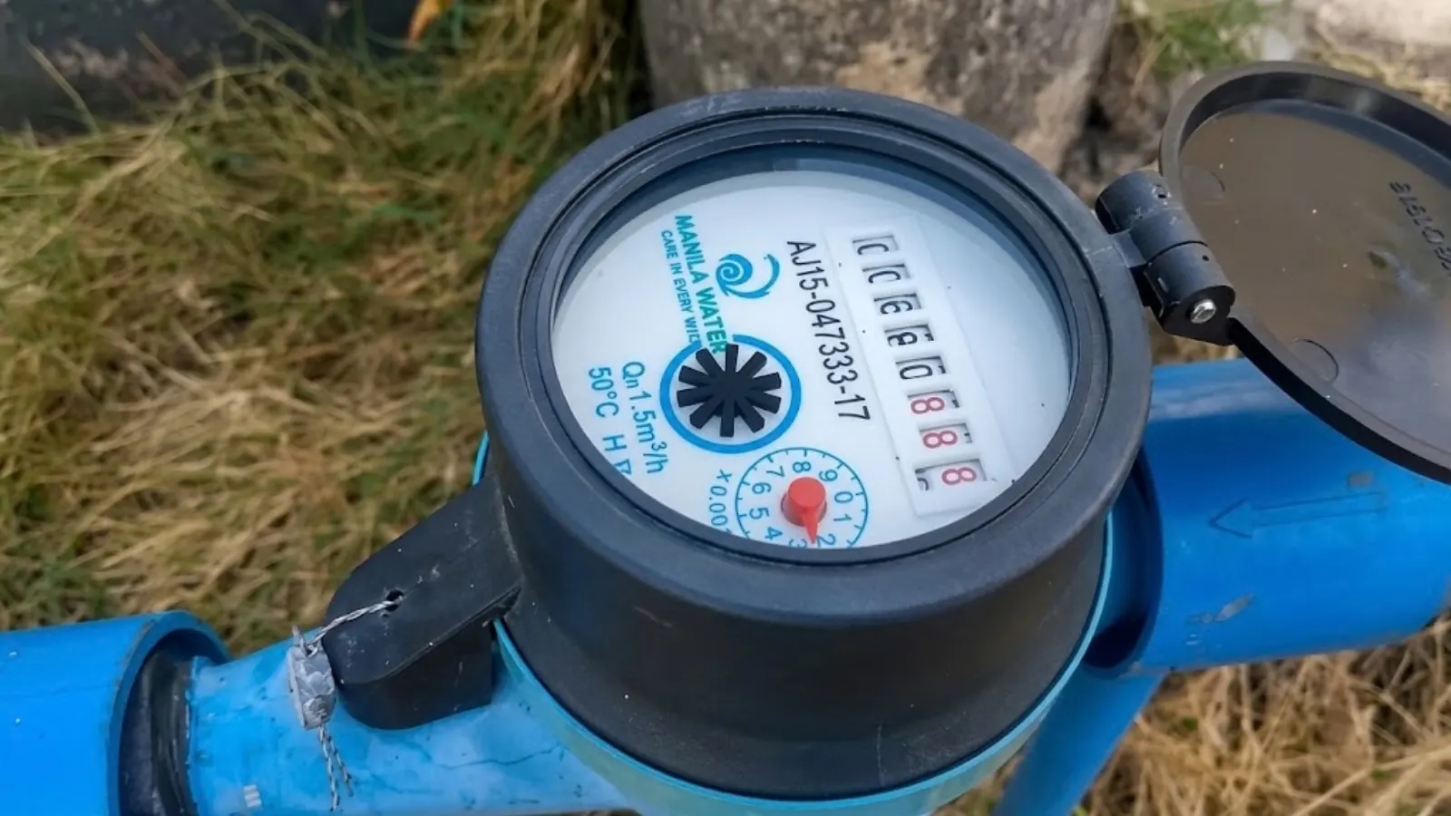 Close-up of a residential water meter dial during a leak check