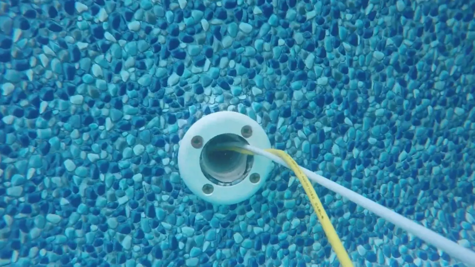 Dye testing at a pool return fitting to check for a leak
