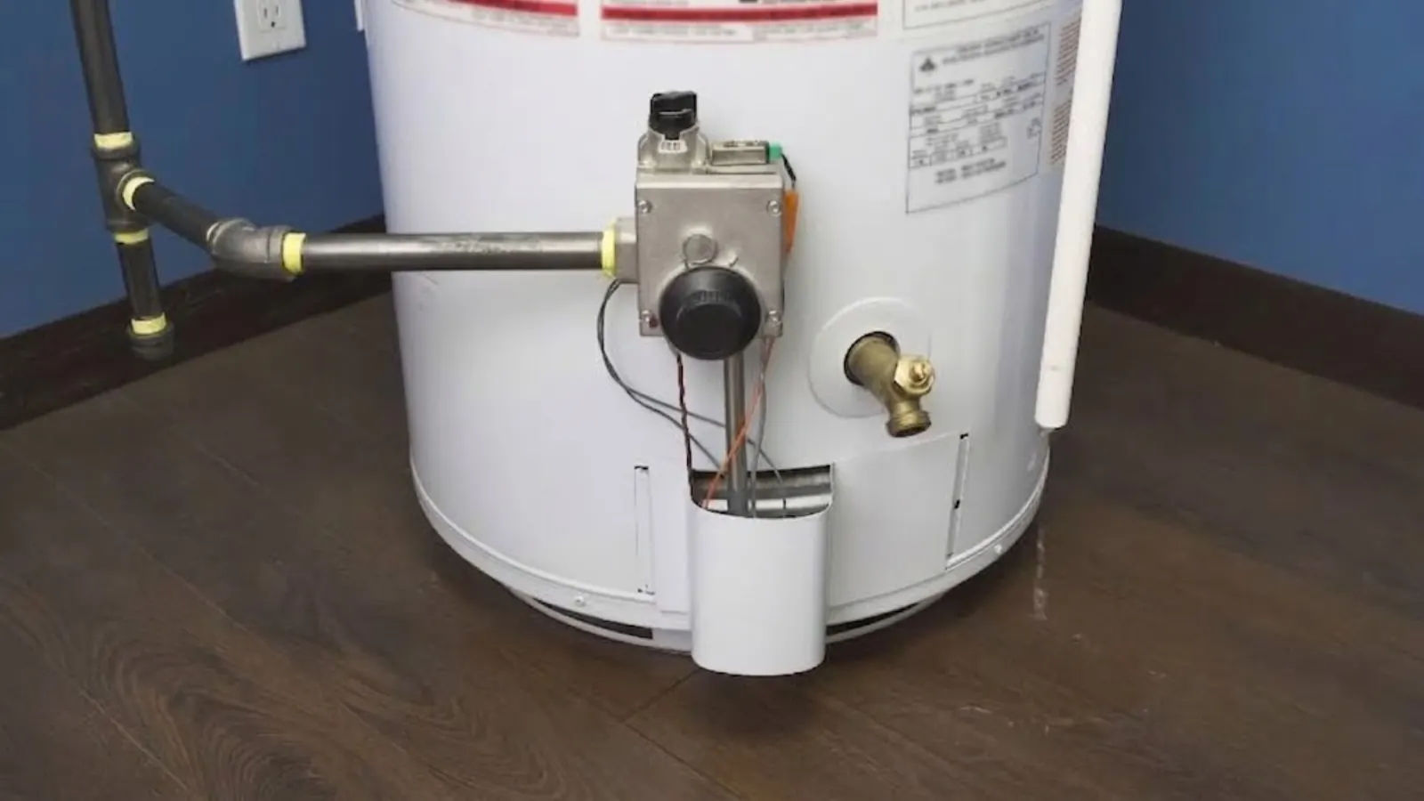 Gas tank water heater with fittings and drain valve checked for a leak